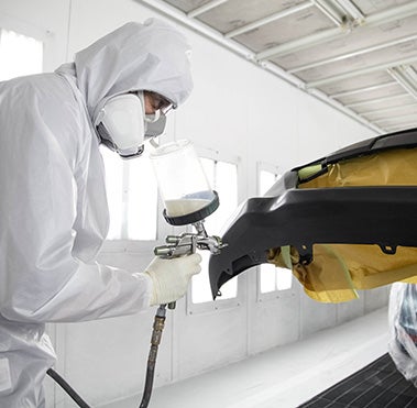 Collision Center Technician Painting a Vehicle | Mount Airy Toyota in Mount Airy NC