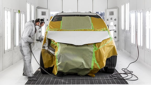 Collision Center Technician Painting a Vehicle | Mount Airy Toyota in Mount Airy NC